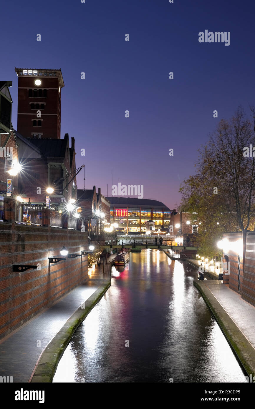 A night time, shot of the Old Main Line canal in Birmingham city center as it passes through Brindley Place. The area is illuminated with street light Stock Photo