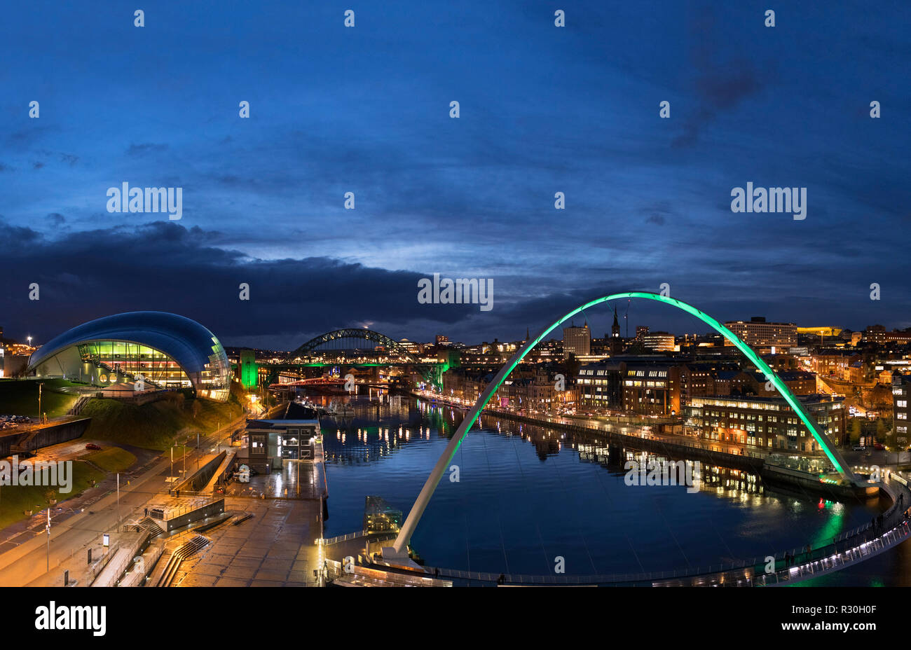 The Gateshead Millennium Bridge looking towards the Sage Gateshead and Tyne Bridge, River Tyne, Newcastle upon Tyne, Tyne and Wear, England, UK Stock Photo