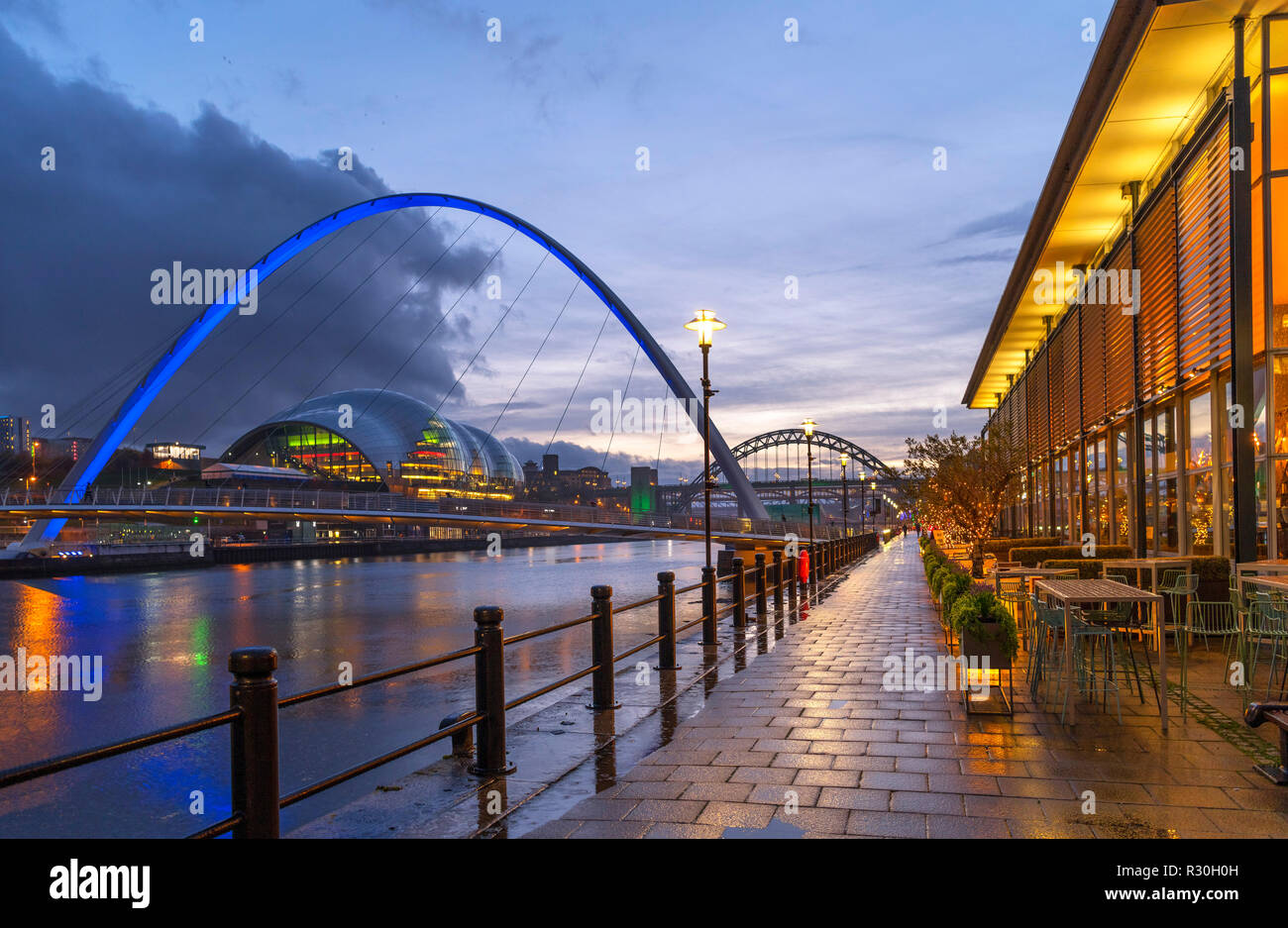 Waterfront bar on the Quayside looking towards Gateshead Millennium Bridge, Sage Gateshead and Tyne Bridge, Newcastle upon Tyne, England, UK Stock Photo