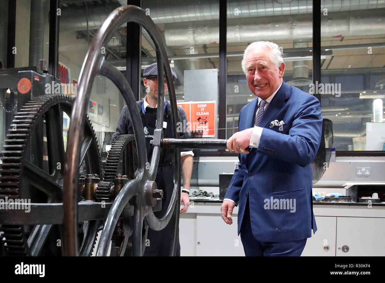 The Prince of Wales turns the wheel of the large Haddon etching press