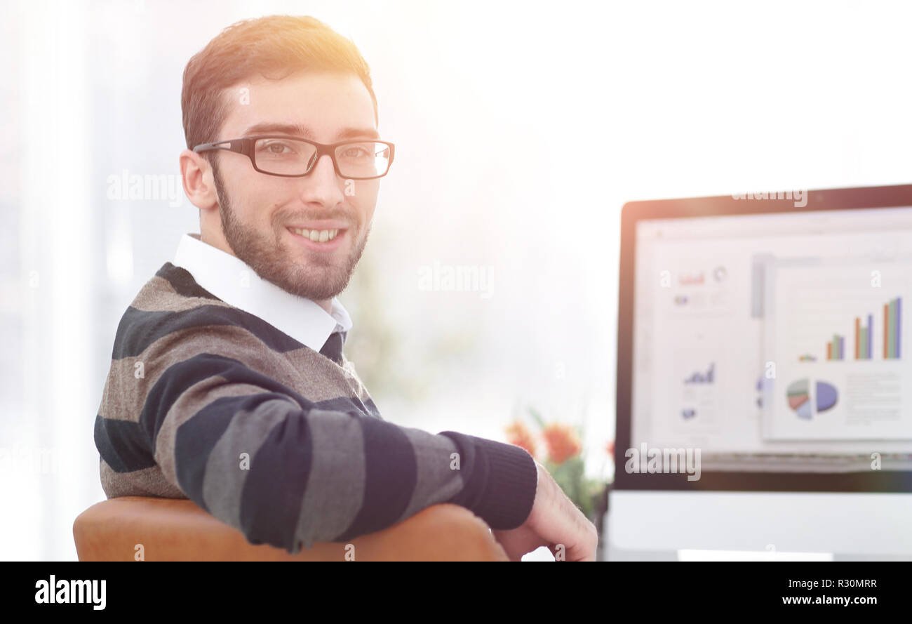 businessman analyzing financial graphs on computer Stock Photo