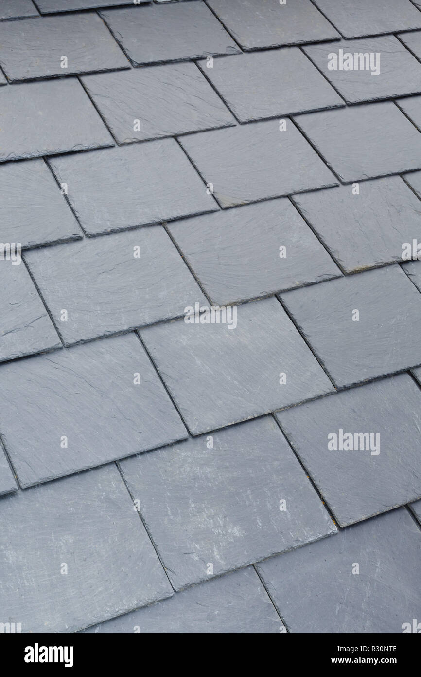 Detail of traditional gray slate roof tiles on a pitched roof Stock Photo