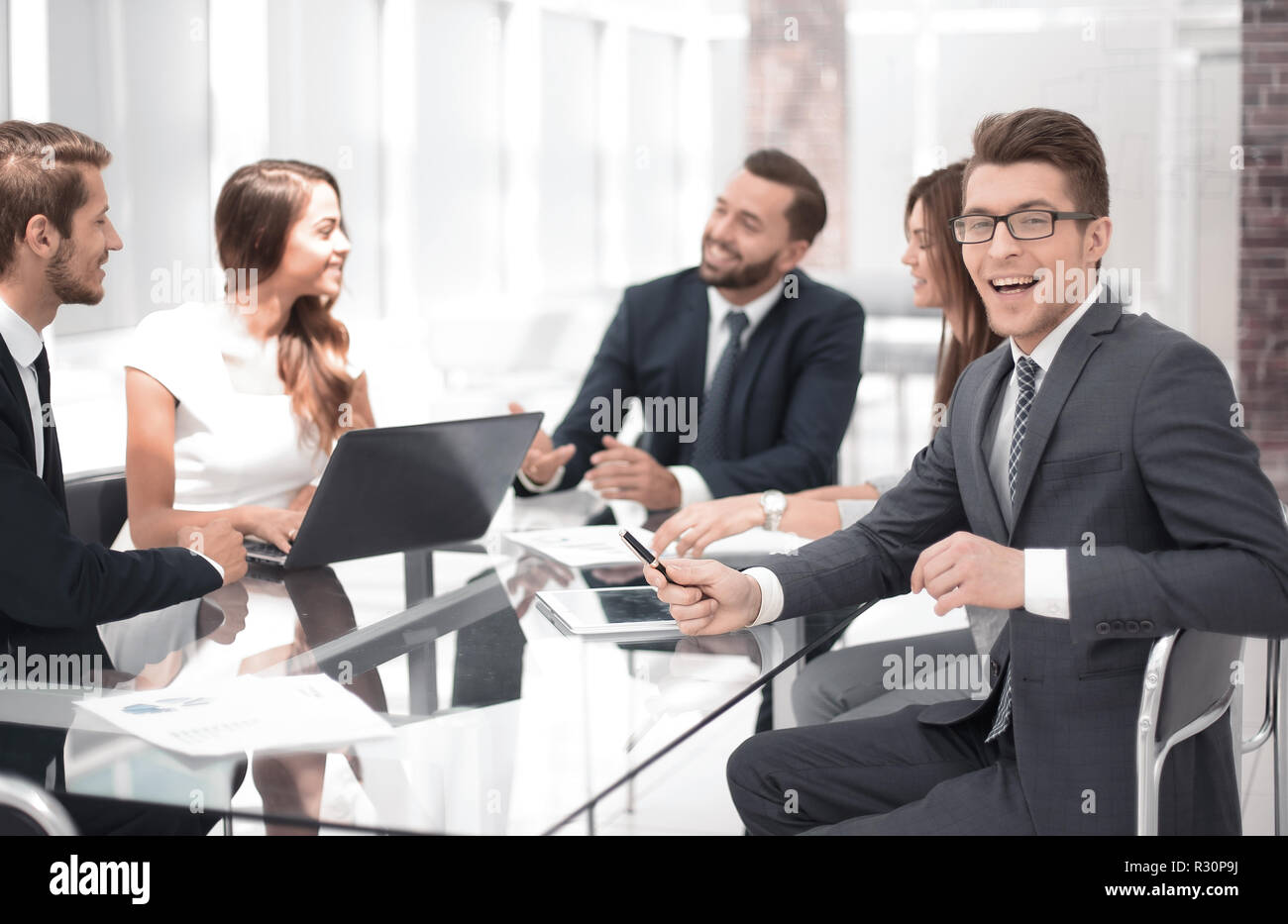 successful business team sitting at the office Desk Stock Photo - Alamy