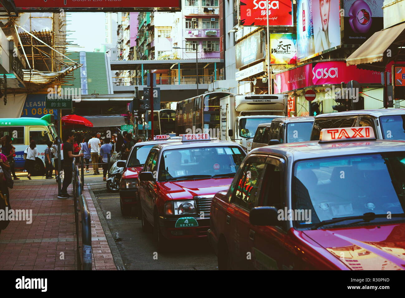 Taxis wait for customers at taxi stand. Mong Kok, Hong Kong. Stock Photo