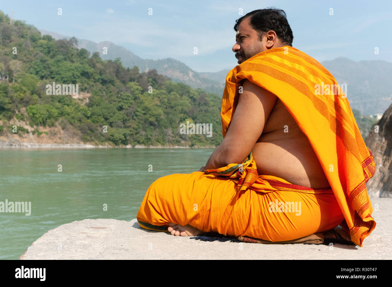 A monk meditating alongside the river Ganges. Rishikesh, India Stock ...
