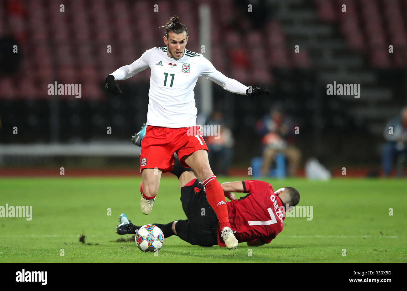 Wales' Gareth Bale (left) and Albania's Eros Grezda (right) battle for the ball during the international friendly match at the Elbasan Arena. Stock Photo