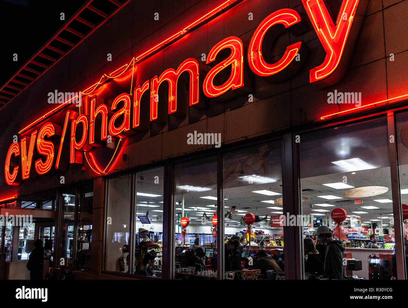 Large and luminous CVS/pharmacy sign across storefront at night, Miami, Florida, USA. Stock Photo
