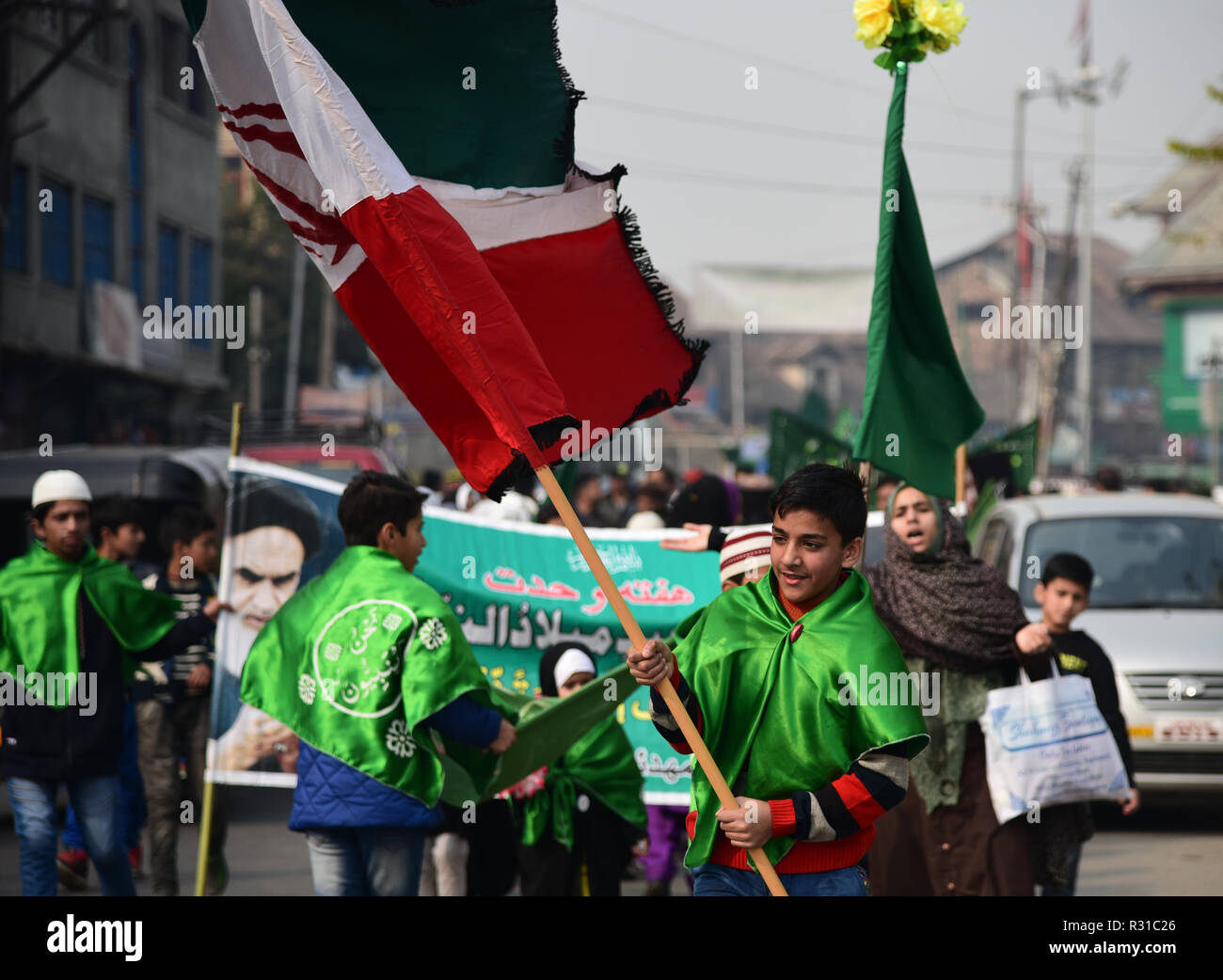 Kashmiri Shia Muslim students waves flags during a march rally marking Eid-i-Milad-un-Nabi, the birth anniversary of Prophet Muhammad PBUH. Muslims across the world celebrated Eid-e-Milad-un-Nabi, the birth anniversary of the Prophet Mohammed on 12 Rabil ul Awal, a month of the Muslim calendar which falls on 21 November 2018. Stock Photo