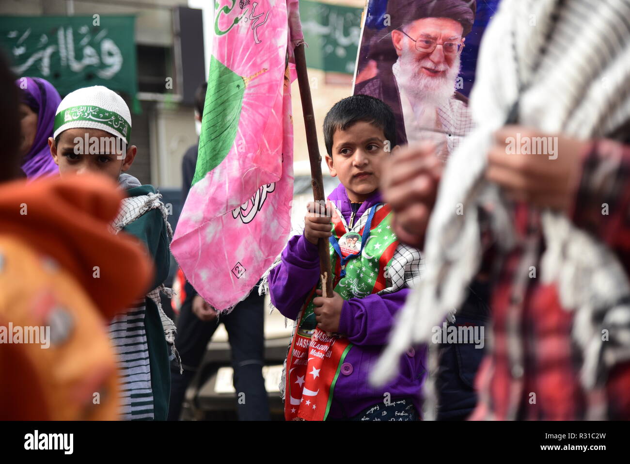 Kashmiri Shia Muslim student seen looking on during a march rally marking Eid-i-Milad-un-Nabi, the birth anniversary of Prophet Muhammad PBUH. Muslims across the world celebrated Eid-e-Milad-un-Nabi, the birth anniversary of the Prophet Mohammed on 12 Rabil ul Awal, a month of the Muslim calendar which falls on 21 November 2018. Stock Photo