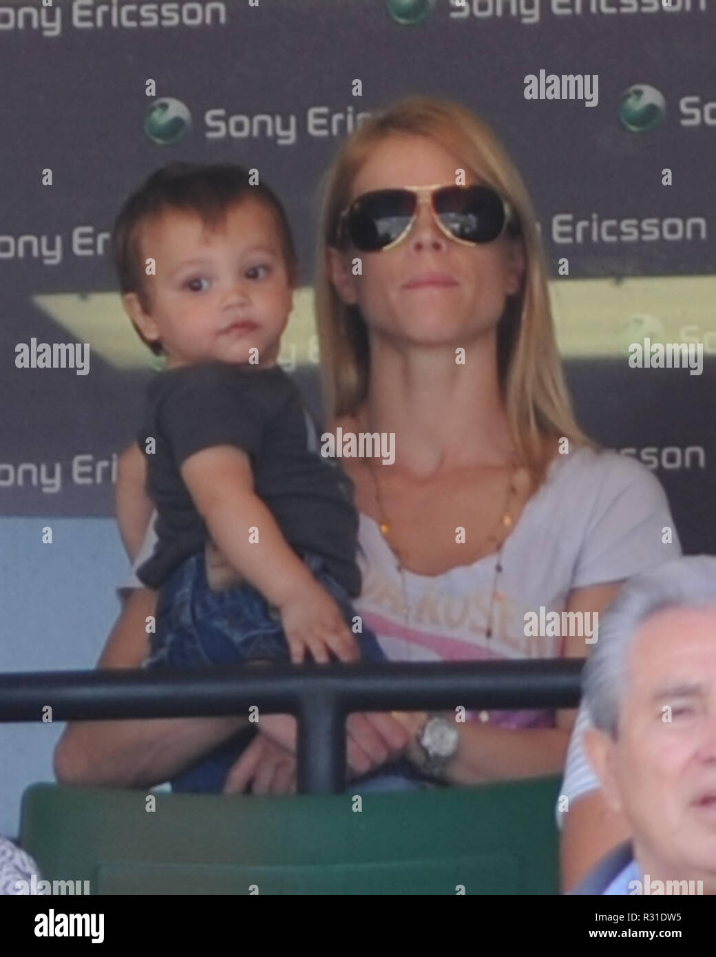 KEY BISCAYNE, FL - APRIL 02: Elin Nordegren wife of disgraced golfer, Tiger Woods apparently was in a Michael Jackson mood today when she wore one glove to cover her ring finger. (she was NOT wearing her wedding ring) watches with her baby Charlie Axel Woods as Rafael Nadal of Spain takes on Andy Roddick of the United States during day eleven of the 2010 Sony Ericsson Open at Crandon Park Tennis Center on April 2, 2010 in Key Biscayne, Florida.   People:  Elin Nordegren Charlie Axel Woods Stock Photo