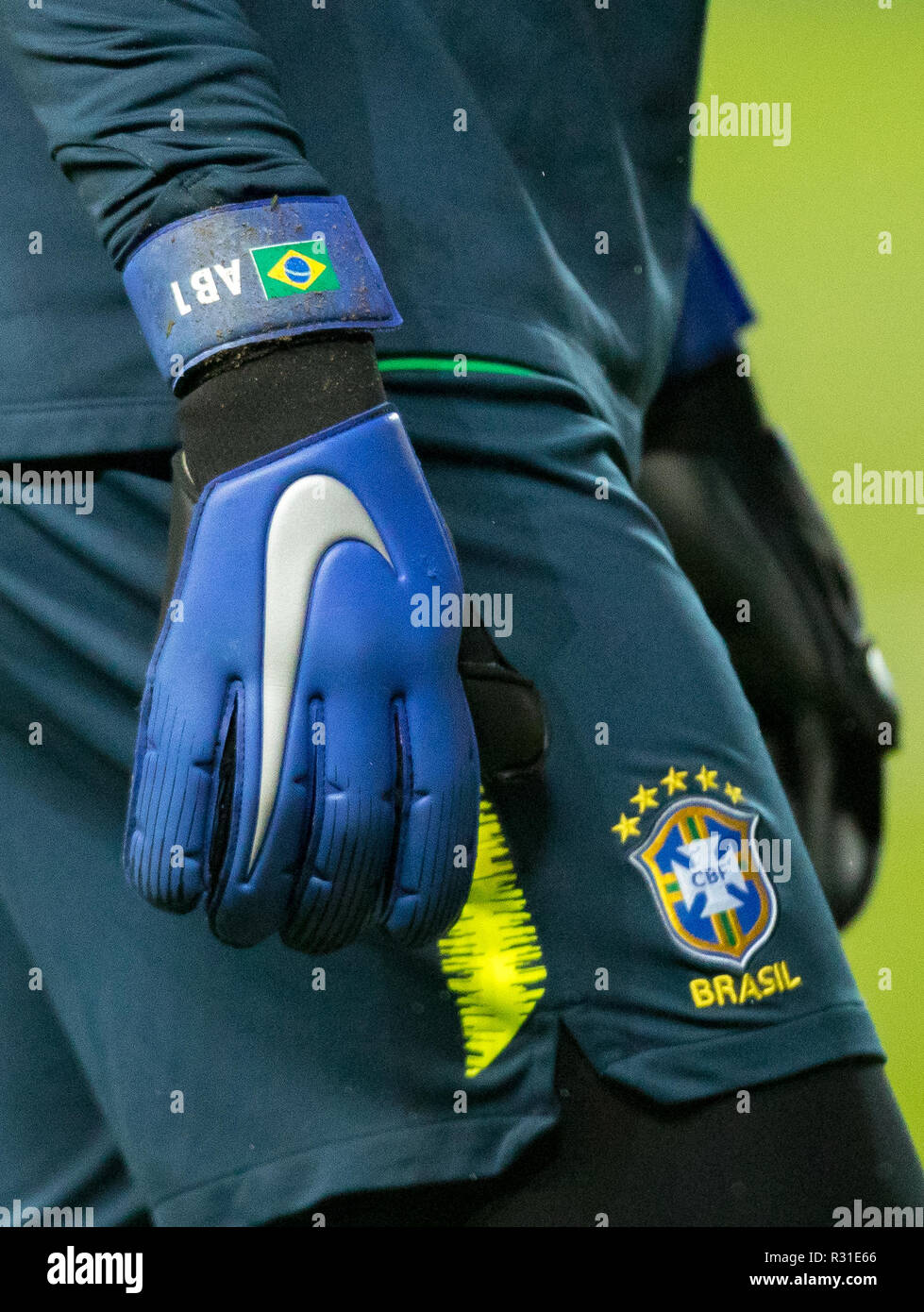 Milton Keynes, UK. 20th Nov 2018. The Nike goalkeeping gloves of Goalkeeper  Alisson (Liverpool) of Brazil displaying AB1 and Brazilian flag during the  International match between Brazil and Cameroon at stadium:mk, Milton