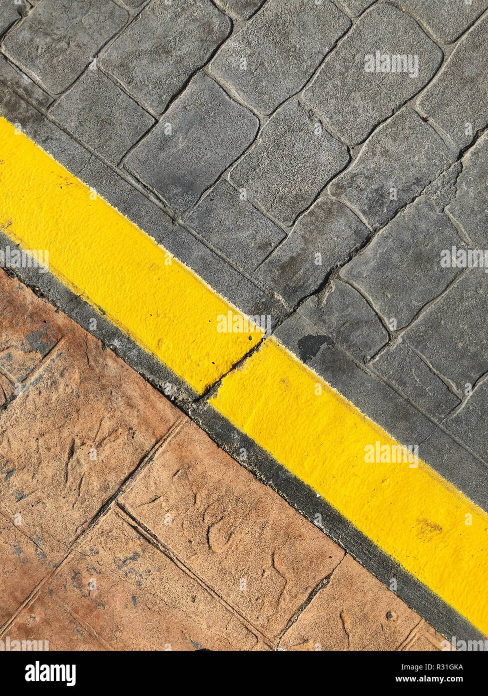 sidewalk background - yellow line on road border marking Stock Photo