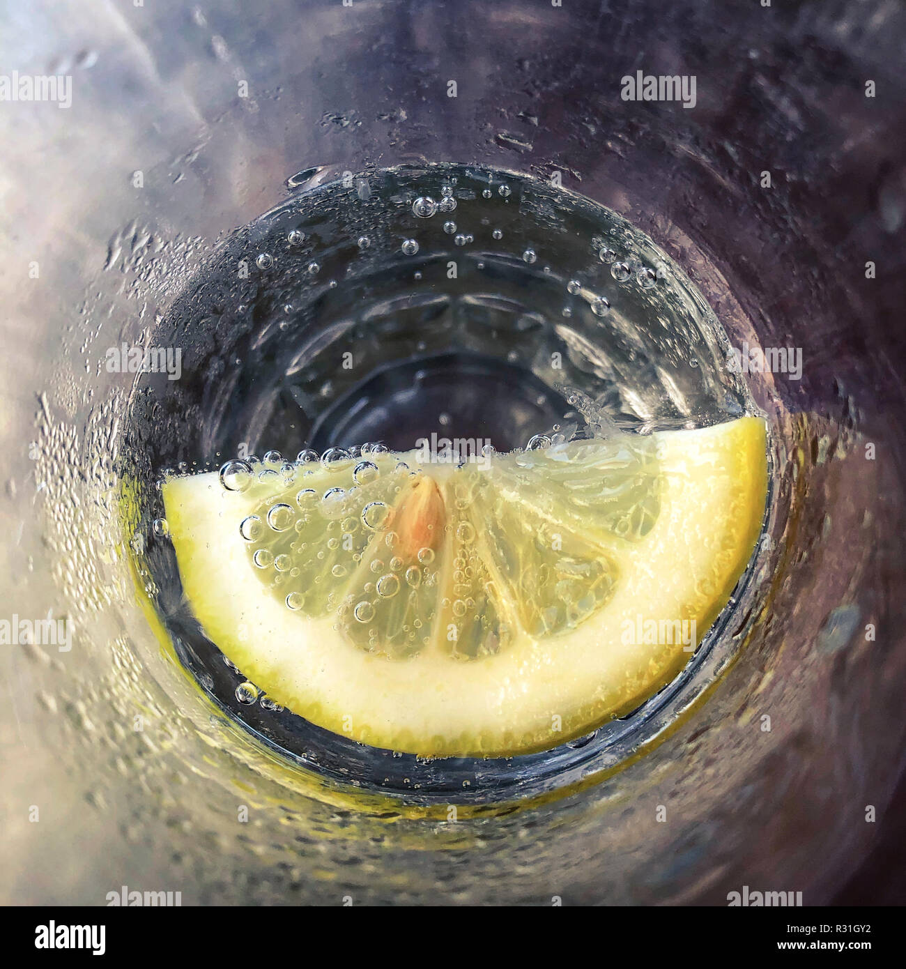 lemon in soda water glass - slice of lemon in drinking glass Stock Photo