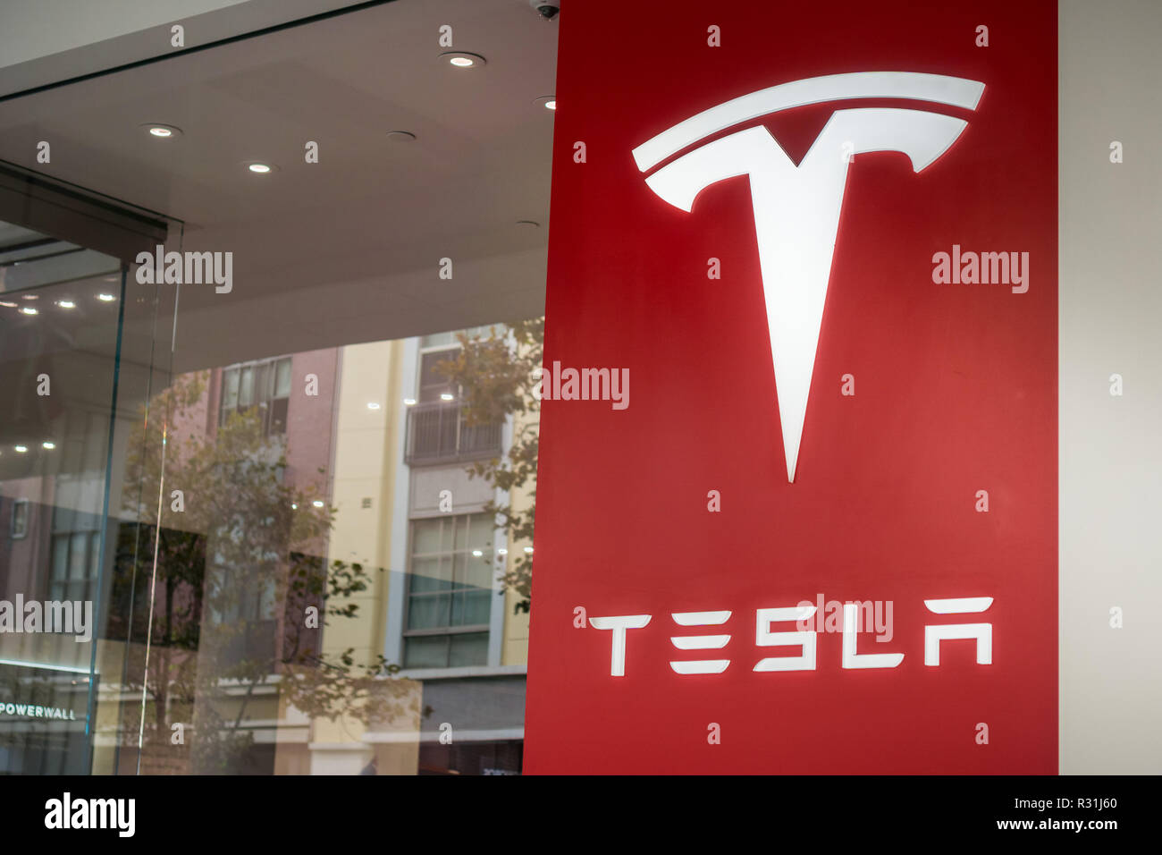 November 8, 2017 San Jose/Ca/USA Tesla logo on the window front of the showroom located in Santana Row shopping district, Silicon Valley, San Francisc Stock Photo