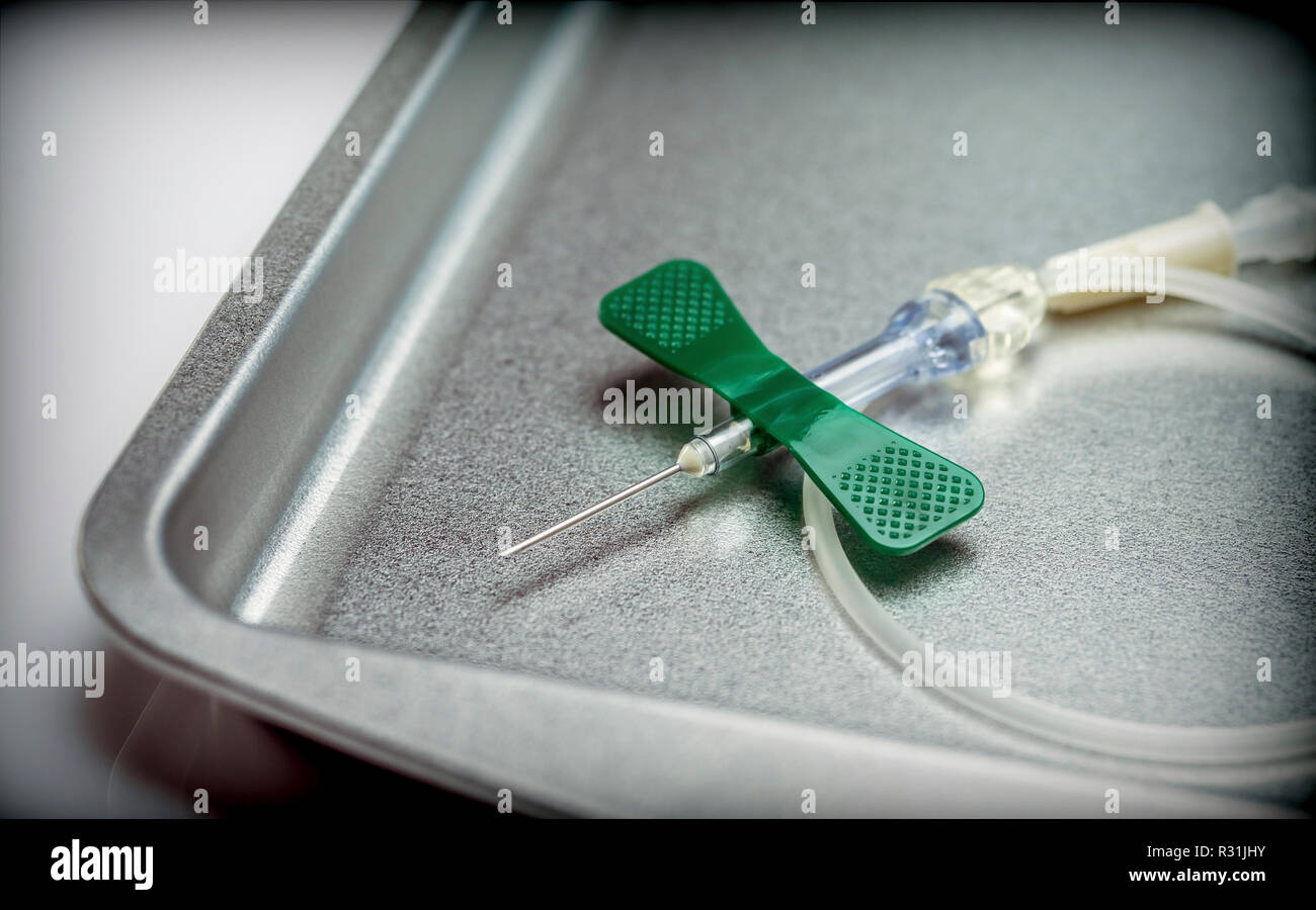 Blood Sample Connector Safety blood collection set adapter on Metal tray in a hospital ...
