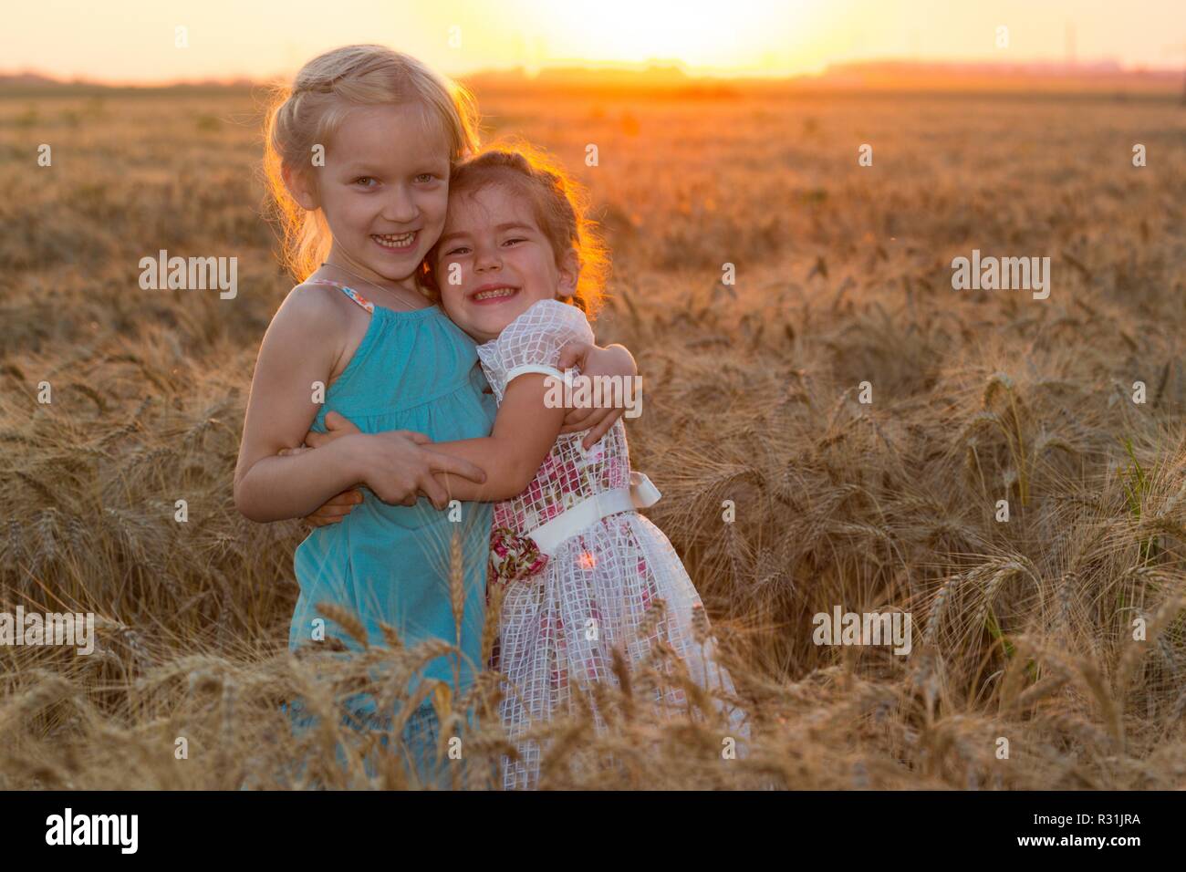 two smiling girls at the wheat field Stock Photo - Alamy