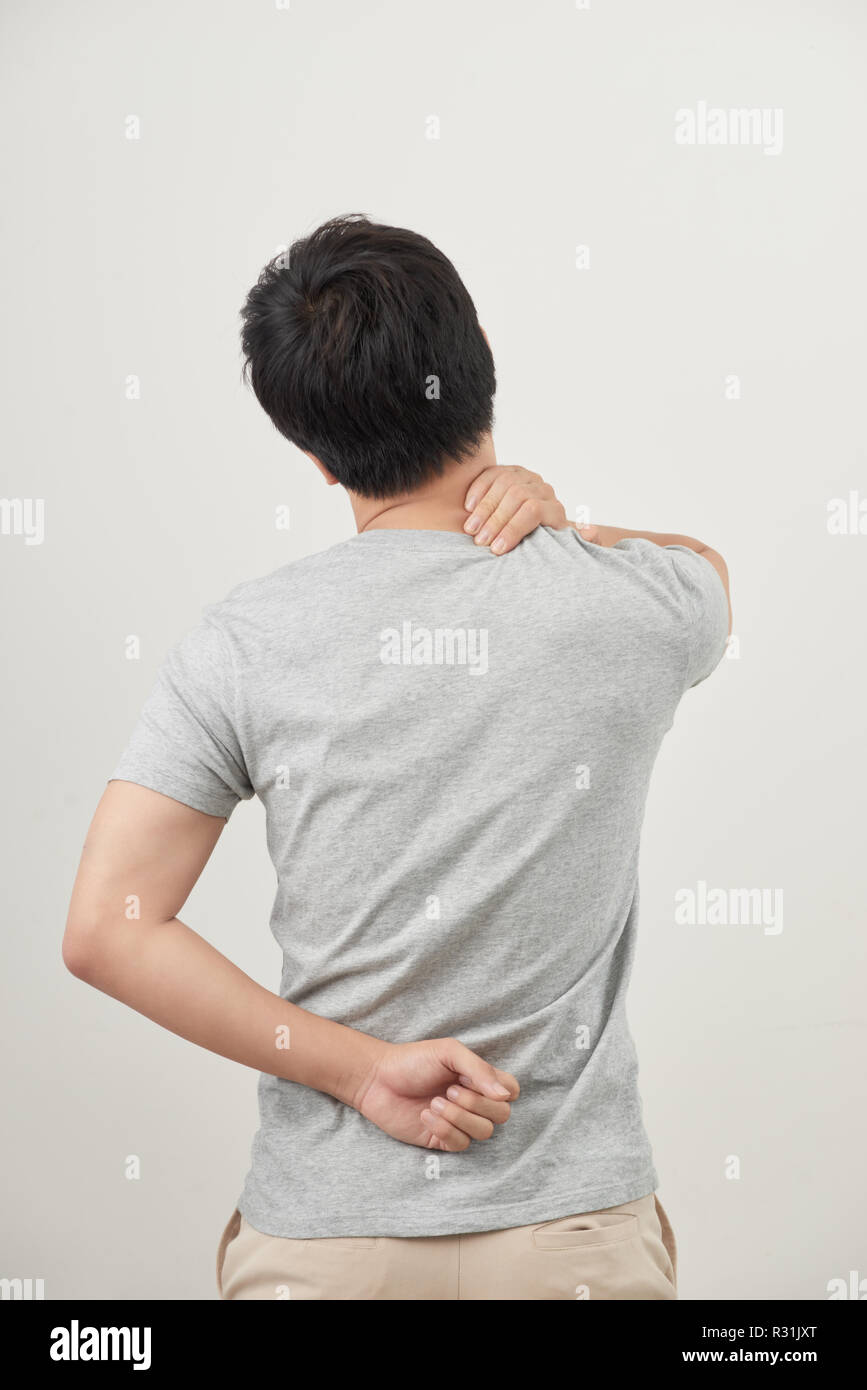 Man rubbing his painful back close up. Business man holding his lower back. Pain relief, chiropractic concept Stock Photo