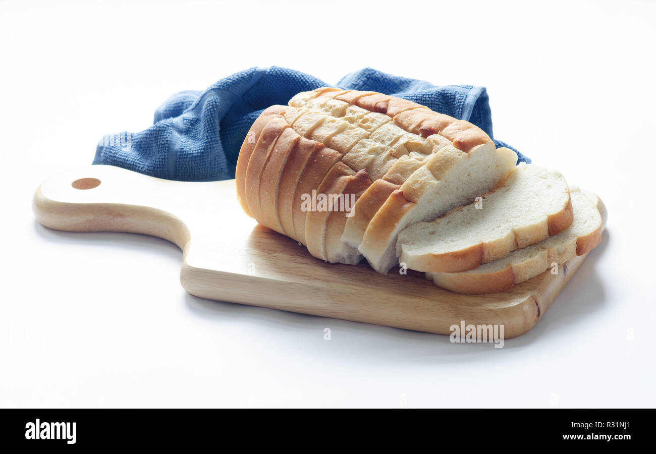 Loaf of sliced italian bread on wood cutting board Stock Photo