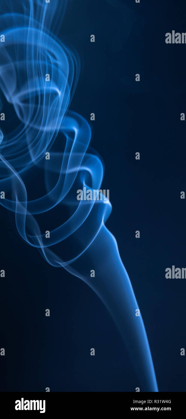 Abstract blue smoke swirls on dark background Stock Photo - Alamy