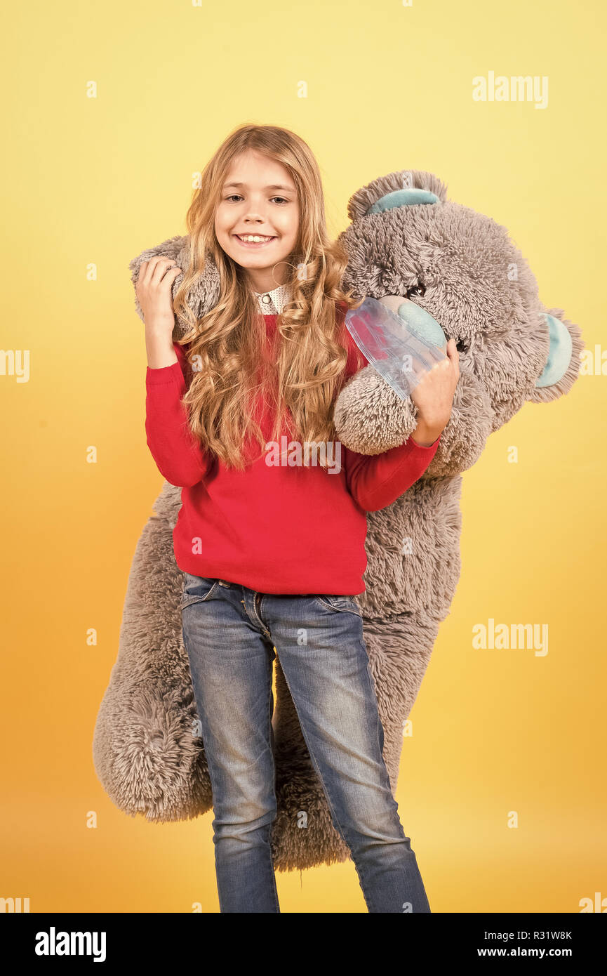girl hugging big teddy bear