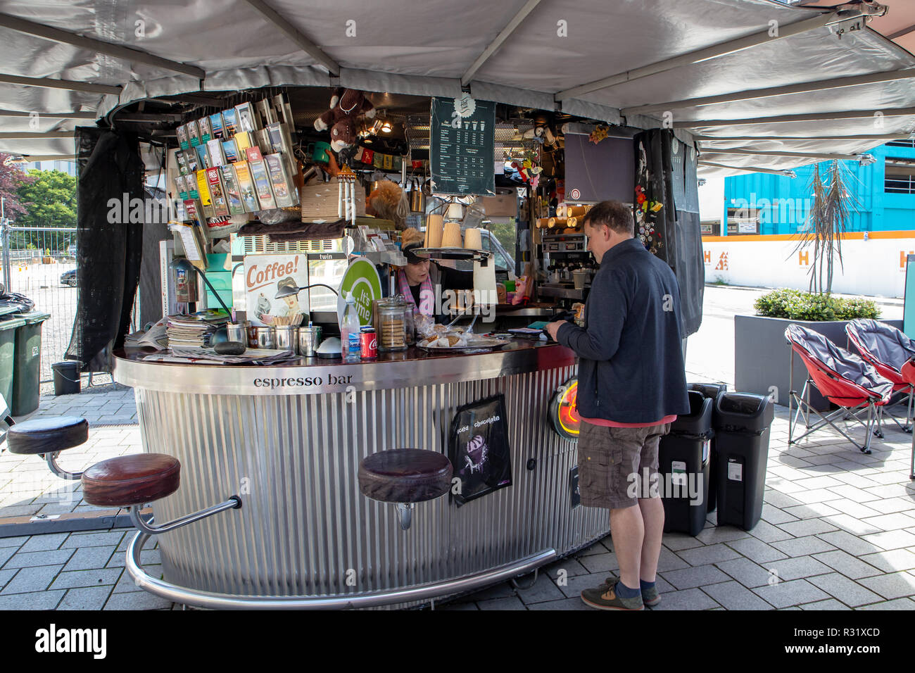A customer is served at an outdoor espresso bar in Christchurch Square, New Zealand Stock Photo