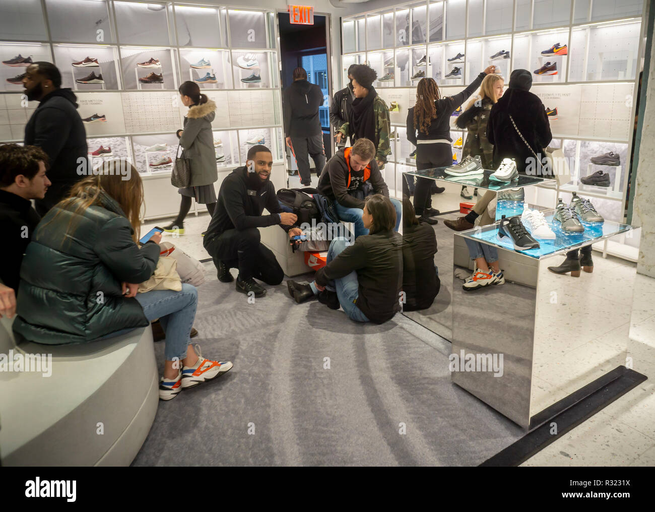 Shoppers try on sneakers in the newly opened Nike flagship store on Fifth  avenue in New York on Saturday, November 17, 2018. The 69,000 square foot  store, dubbed the "House of Innovation