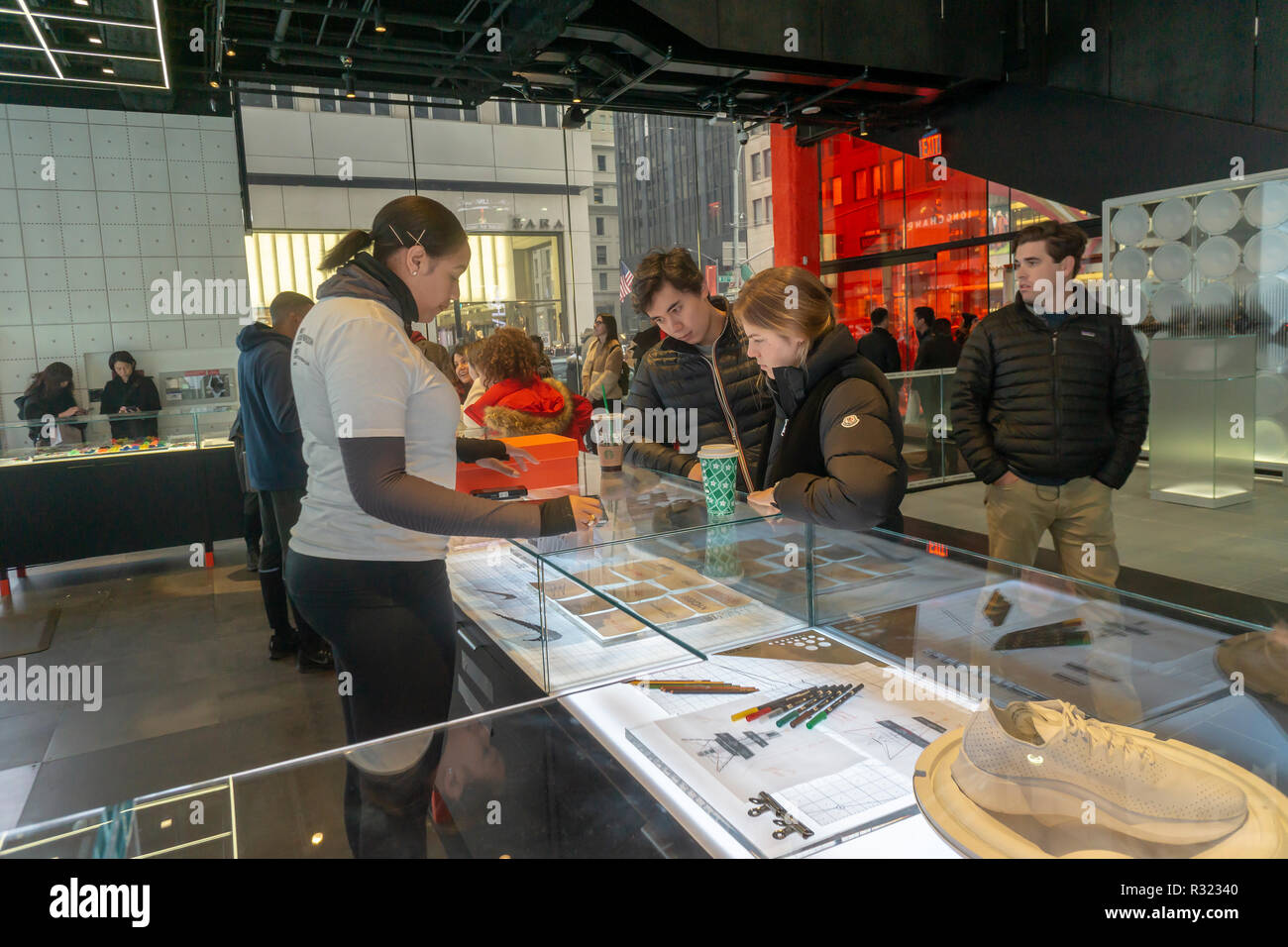 Customization options are discussed at the counter in the newly opened Nike  flagship store on Fifth