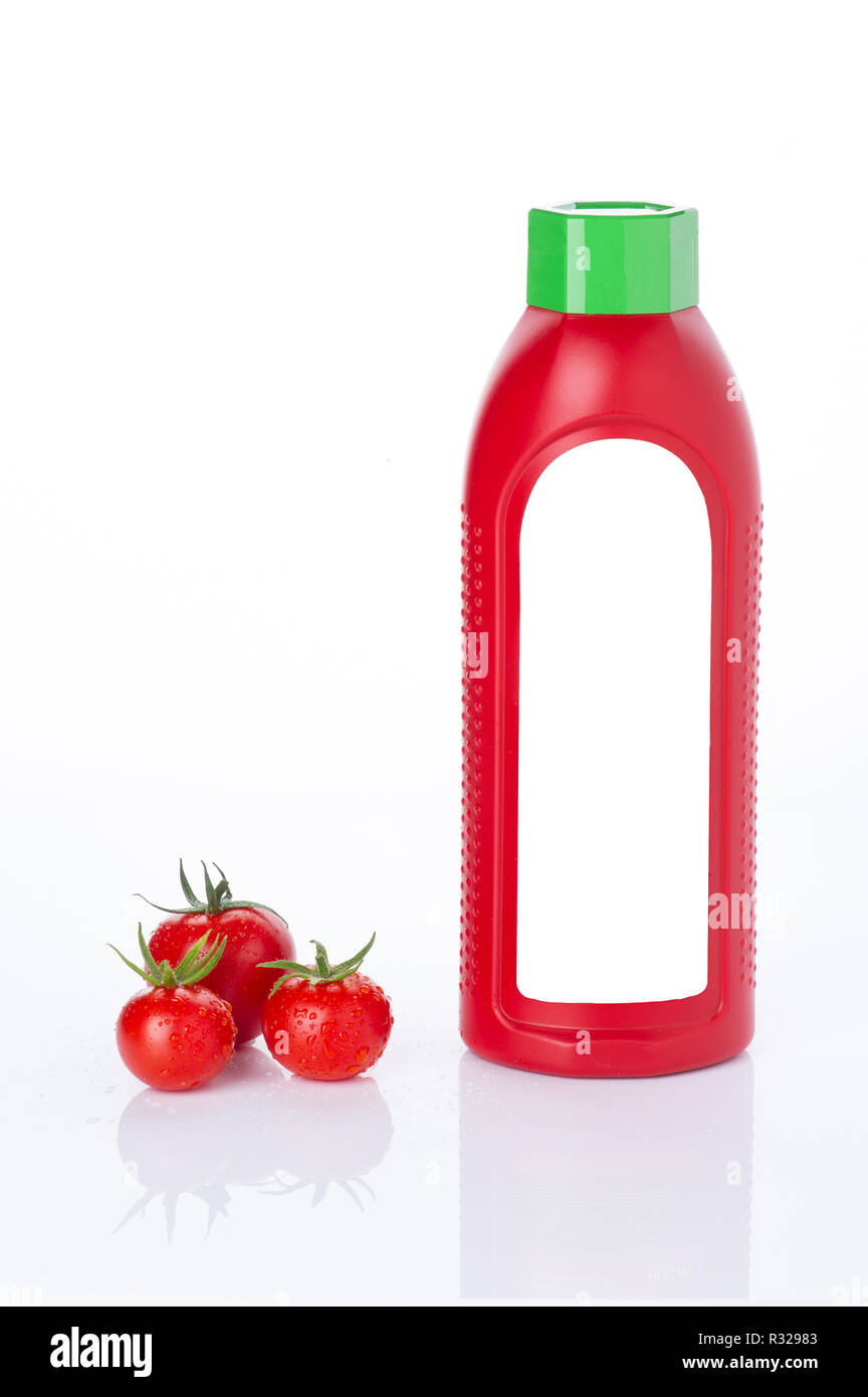 red tomatoes with a ketup bottle Stock Photo