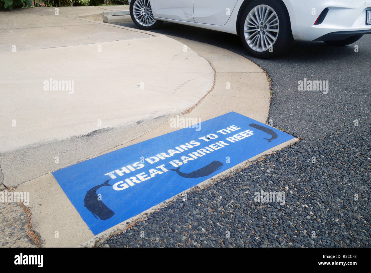 Stencilled sign reminding that this carpark drains to the Great Barrier Reef, Rosslyn Bay marina, Yeppoon, Queensland, Australia. No PR Stock Photo