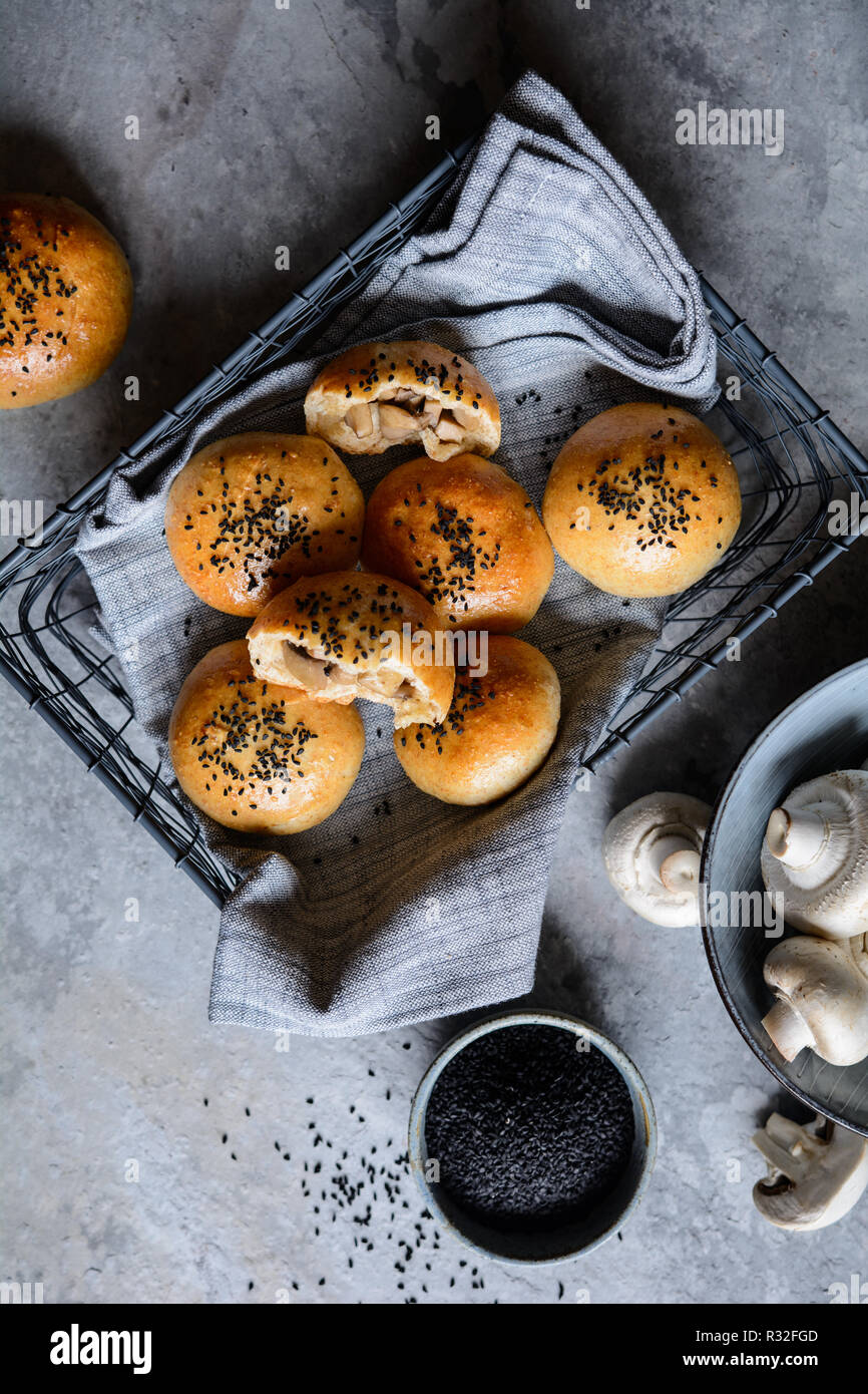 Baked buns stuffed with mushrooms and cheese, studded with black cumin