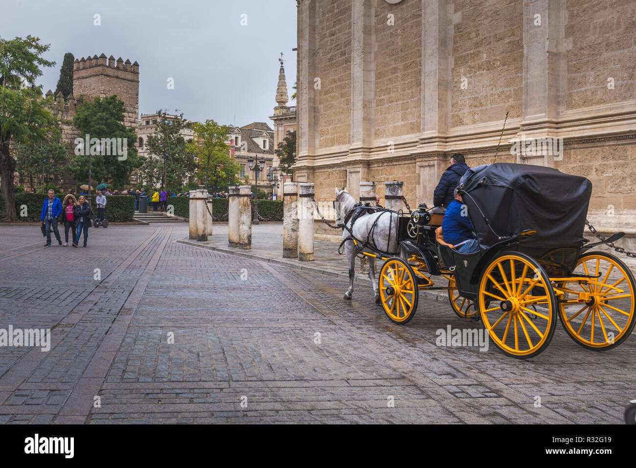 Carriage at Plaza del Triunfo with Cathedral, UNESCO World Heritage Site; Sevilla, Andalusia, Spain Stock Photo