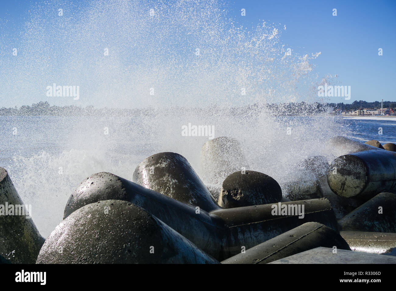 Waves breaking on the concrete blocks protecting the jetty of Santa Cruz Harbor, California Stock Photo