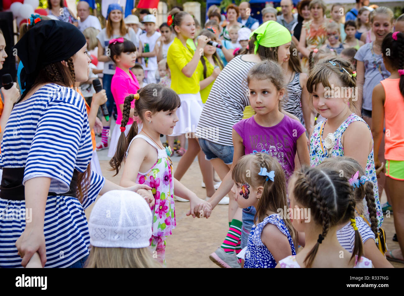 Komsomolsk-on-Amur, Russia - August 1, 2016. Public open Railroader's day.  girl dressed in a pirate costume leads roundelay with group of children  Stock Photo - Alamy, image size:1300x951
