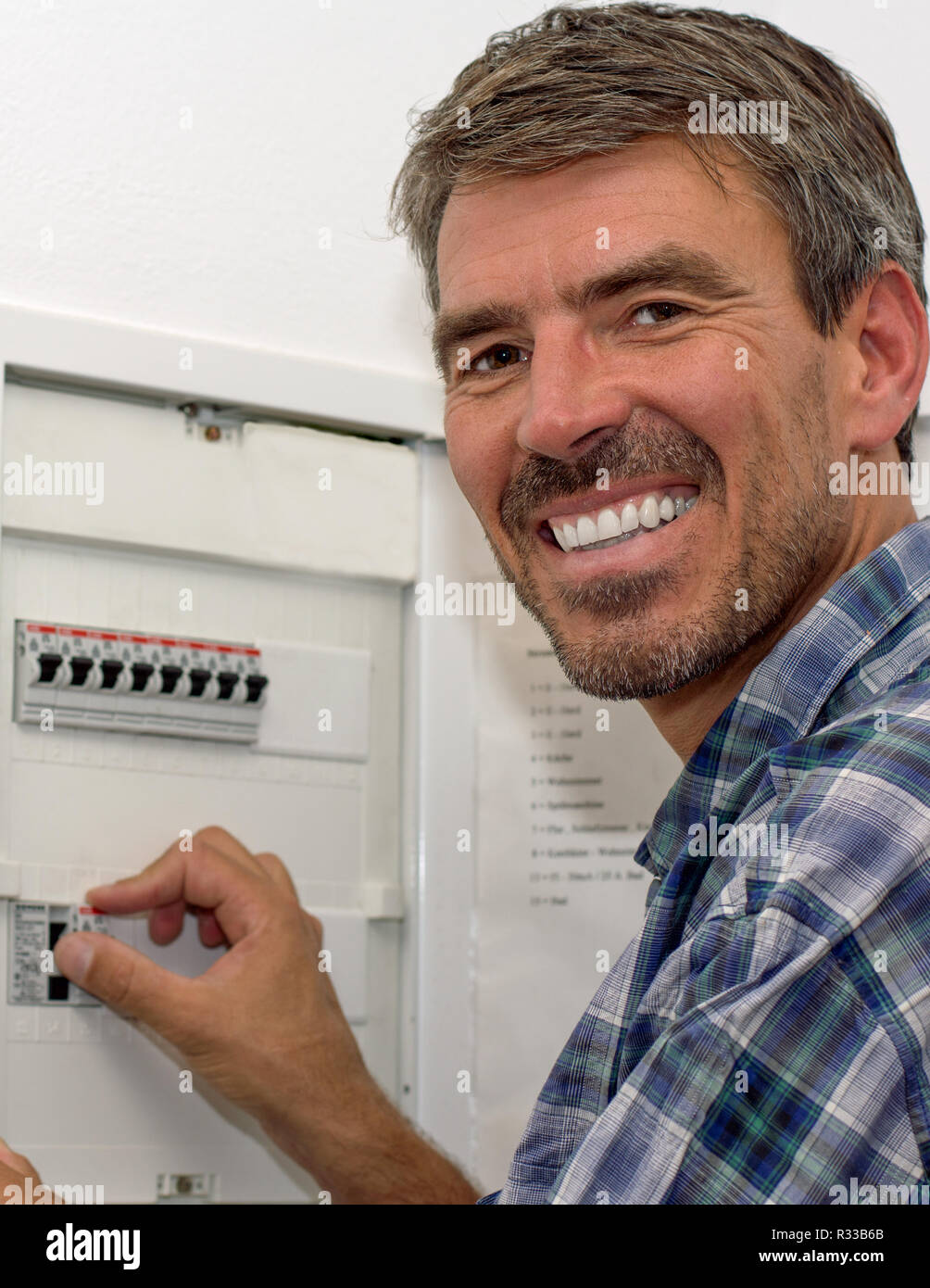 electrician working on the fuse box Stock Photo Alamy