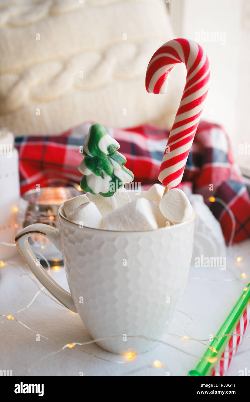 Christmas New Year drink, white mug with marshmallows and Candy