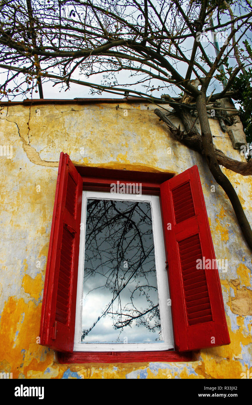 reflection of the sky in an old traditional window, Athens, Greece, Europe Stock Photo