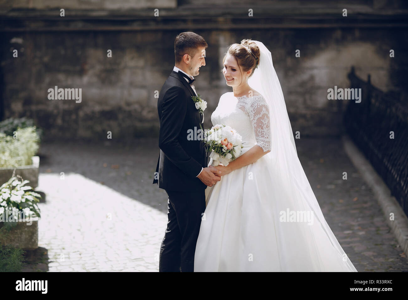 bride and groom walking along the alleys of the city Stock Photo - Alamy