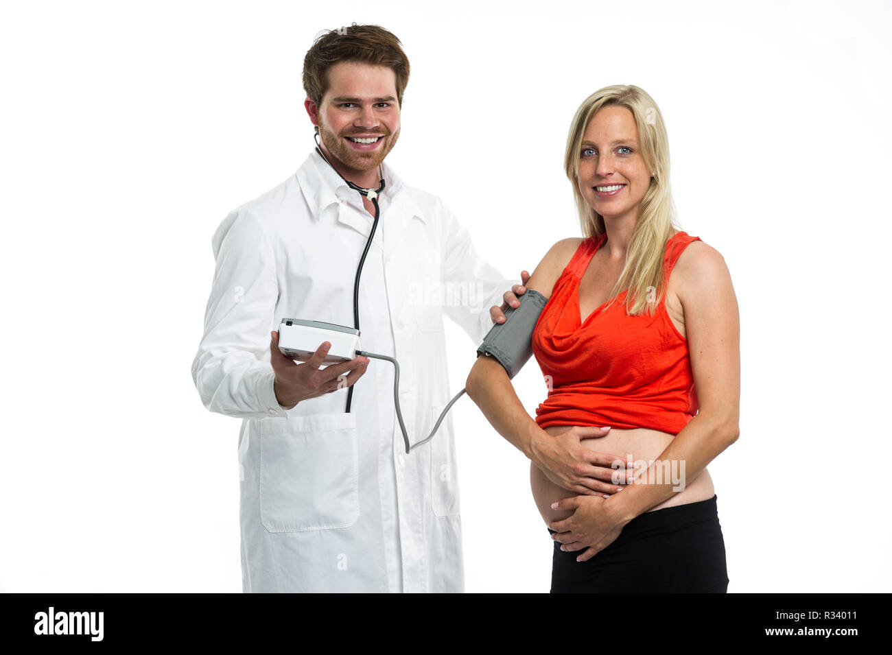 doctor determines the blood pressure of a pregnant woman Stock Photo