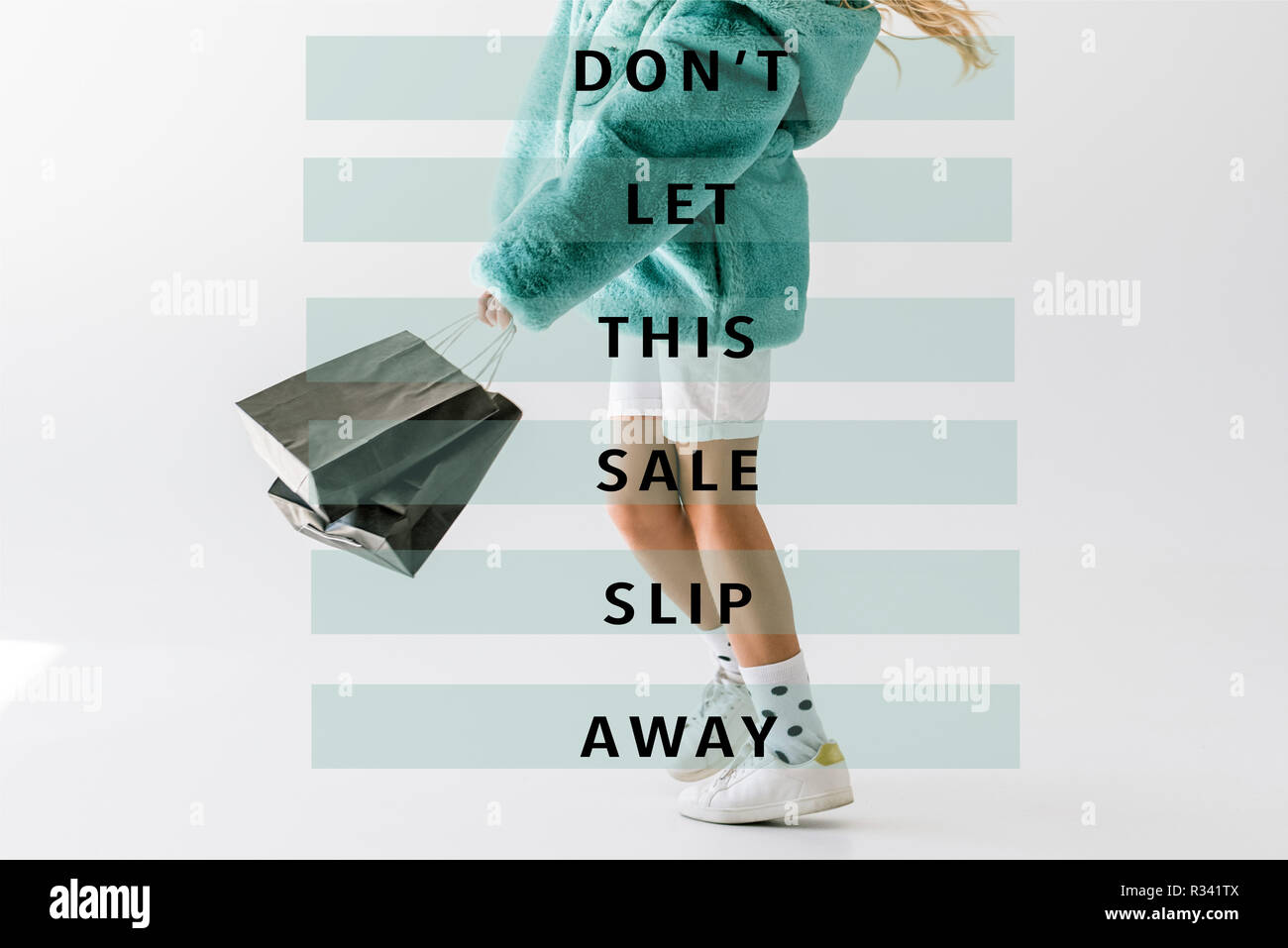 cropped view of girl in turquoise fur coat holding black shopping bags on white, dont let this sale slip away inscription Stock Photo