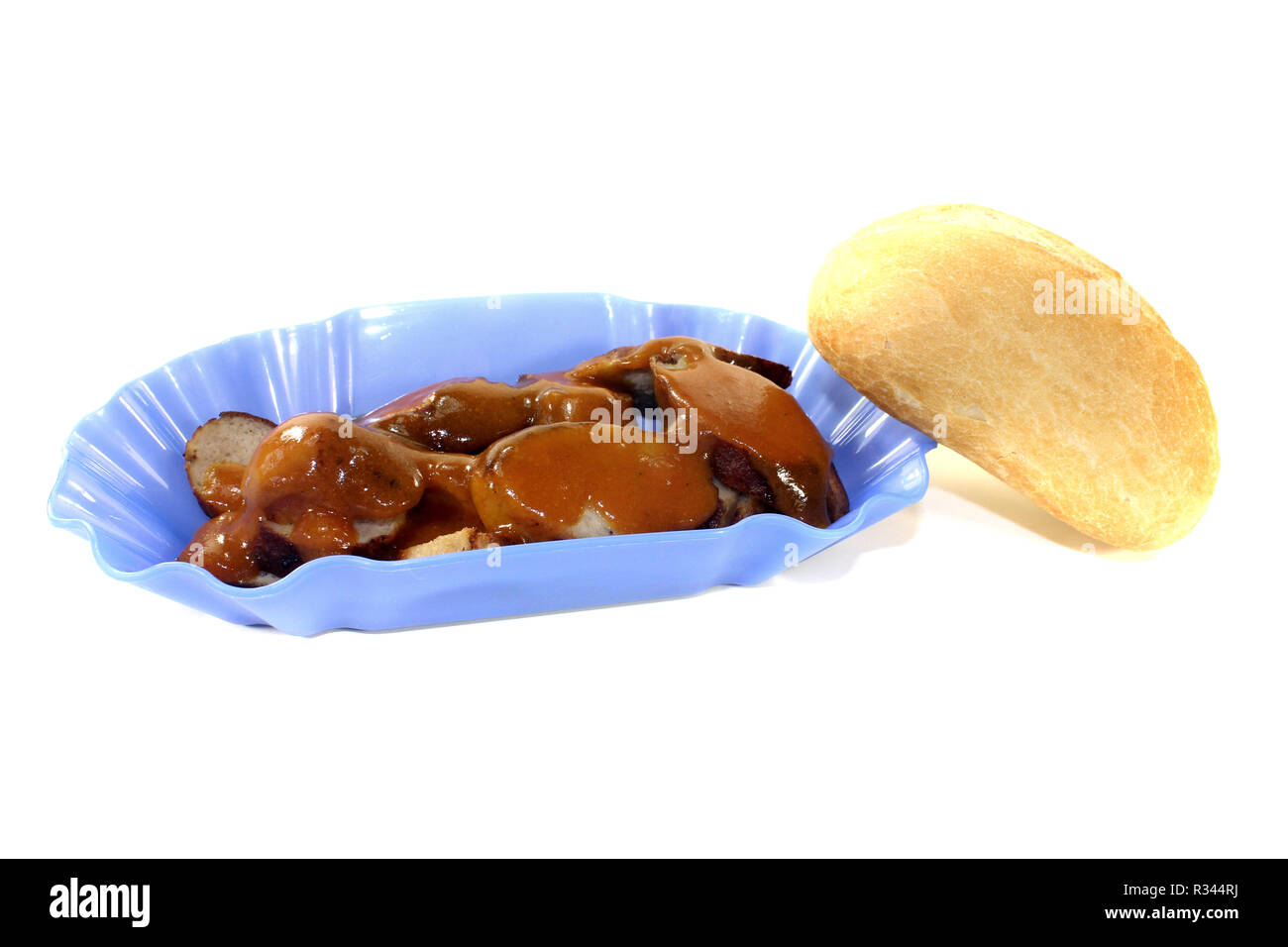 currywurst with bread in a bowl before light background Stock Photo