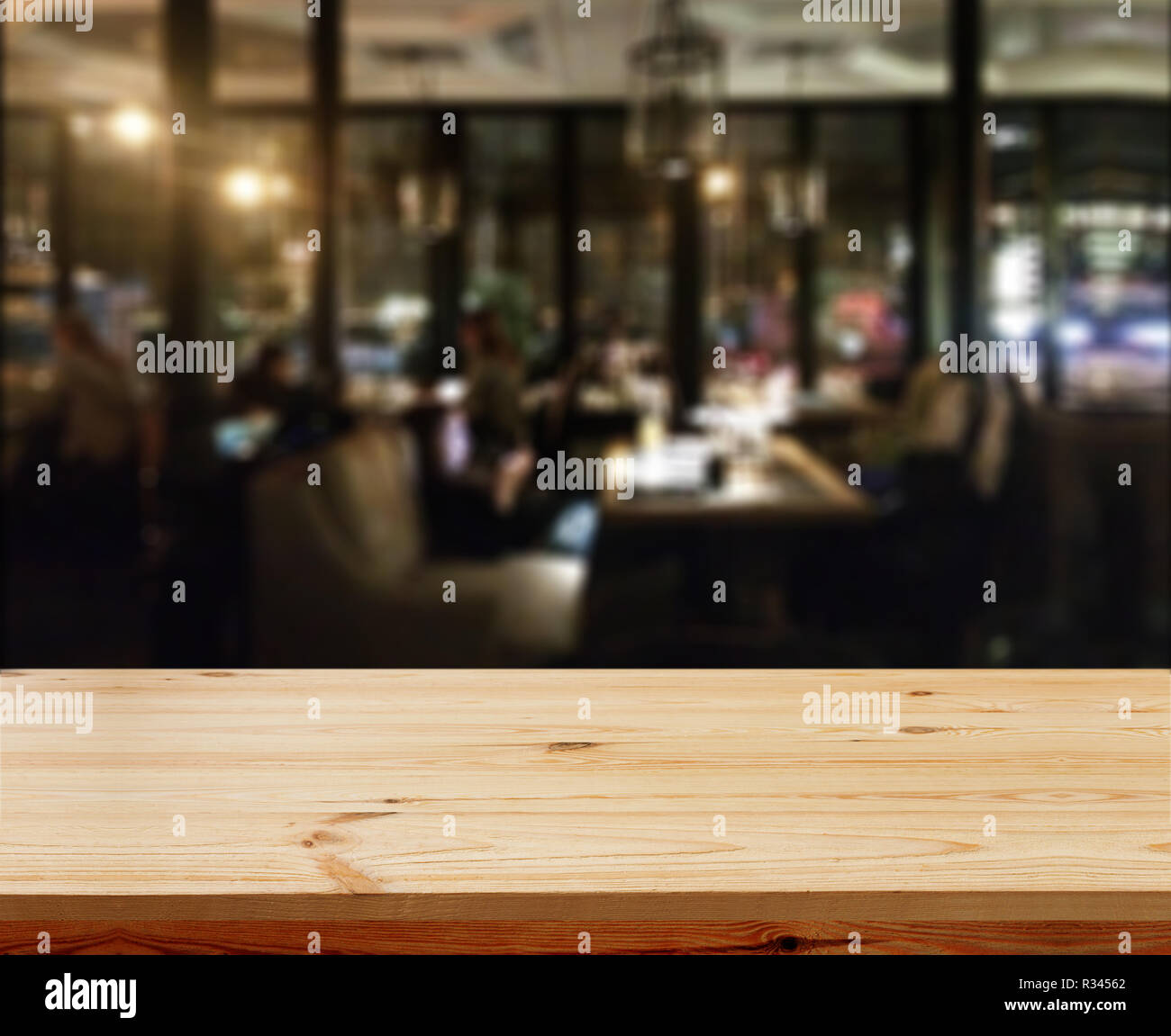 Wooden table with blured background cafe , for your photo montage or product display. Space for placing items on the table. Stock Photo