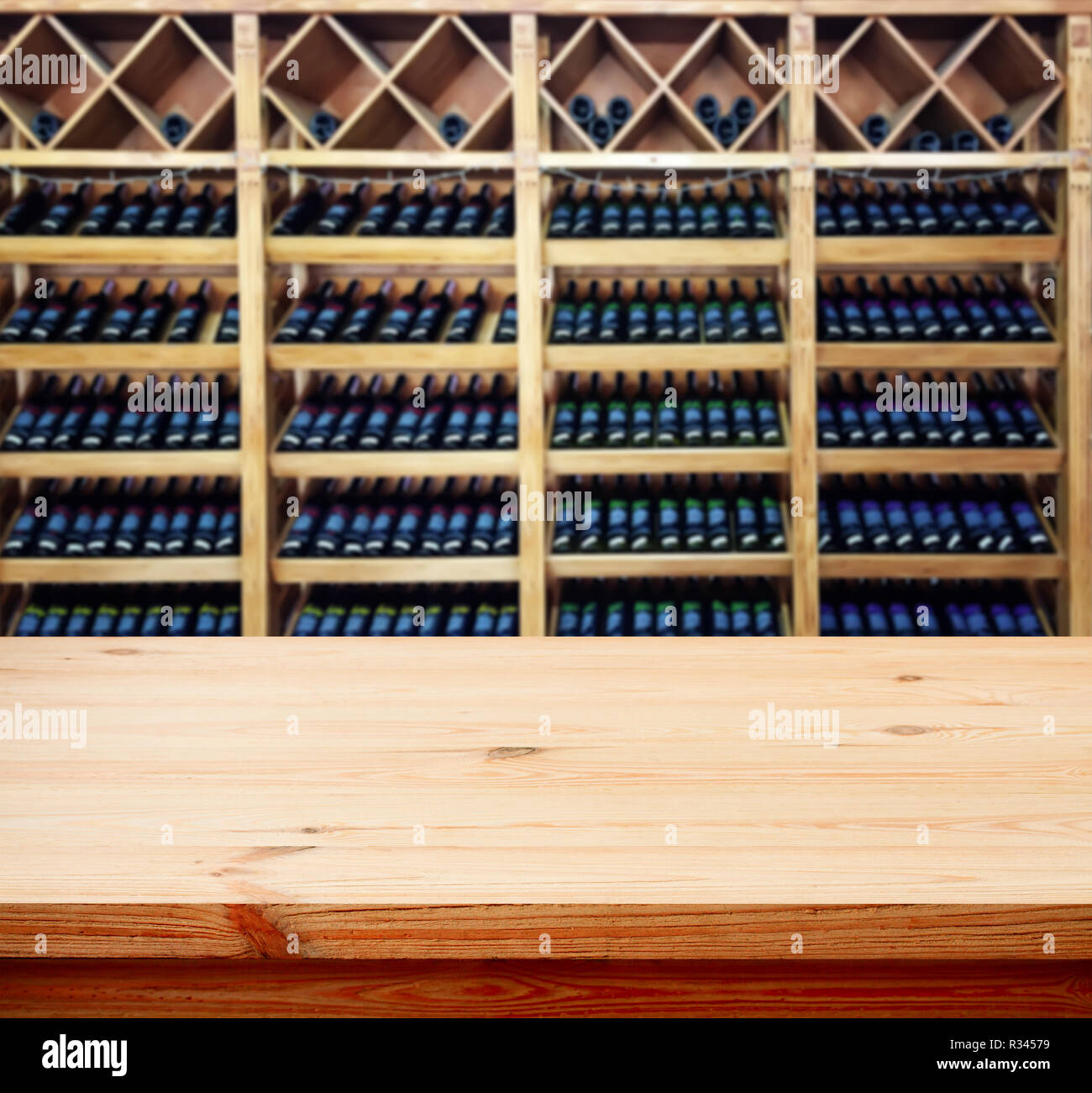 Wooden table with blured background wine bar, for your photo montage or product display. Space for placing items on the table. Front view. Stock Photo