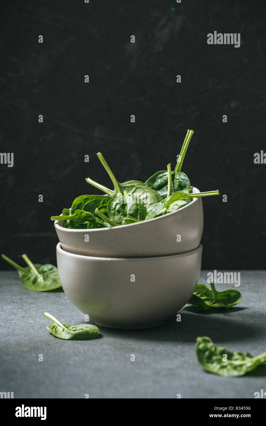 Raw organic spinach leaves in white bowls Stock Photo - Alamy