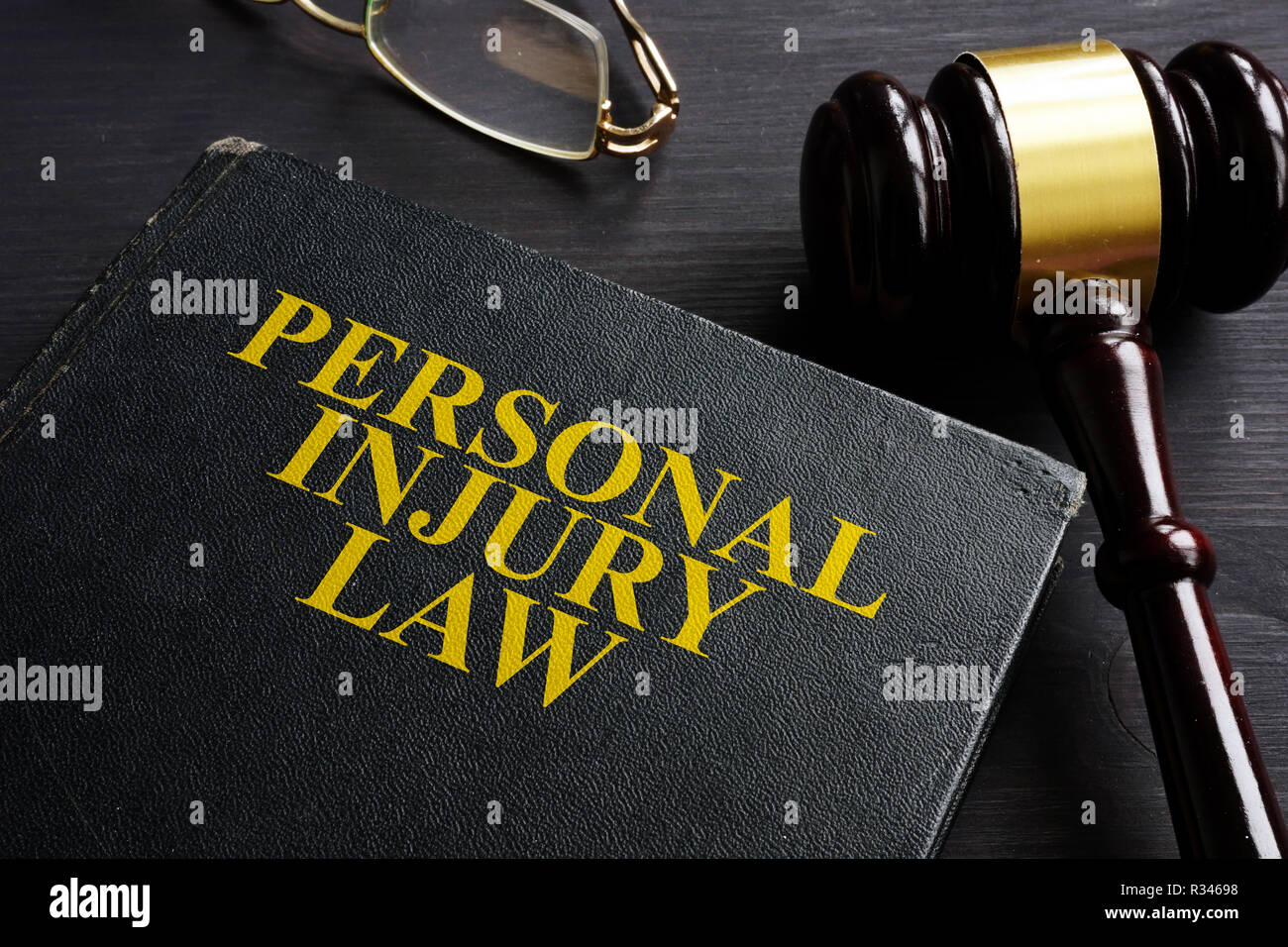 Personal Injury Law book and a black desk. Stock Photo