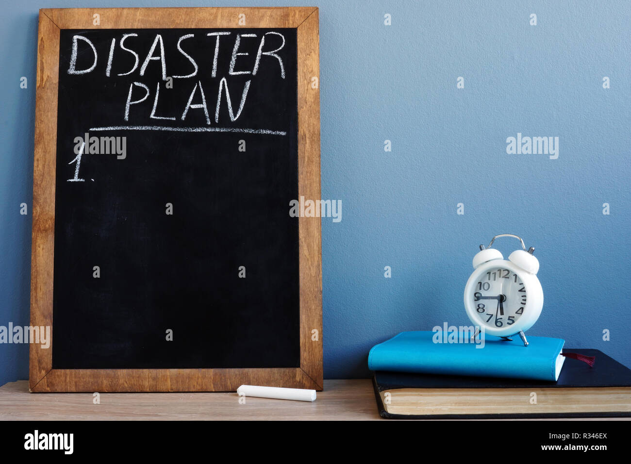 Disaster Plan written on a blackboard and notepads. Stock Photo
