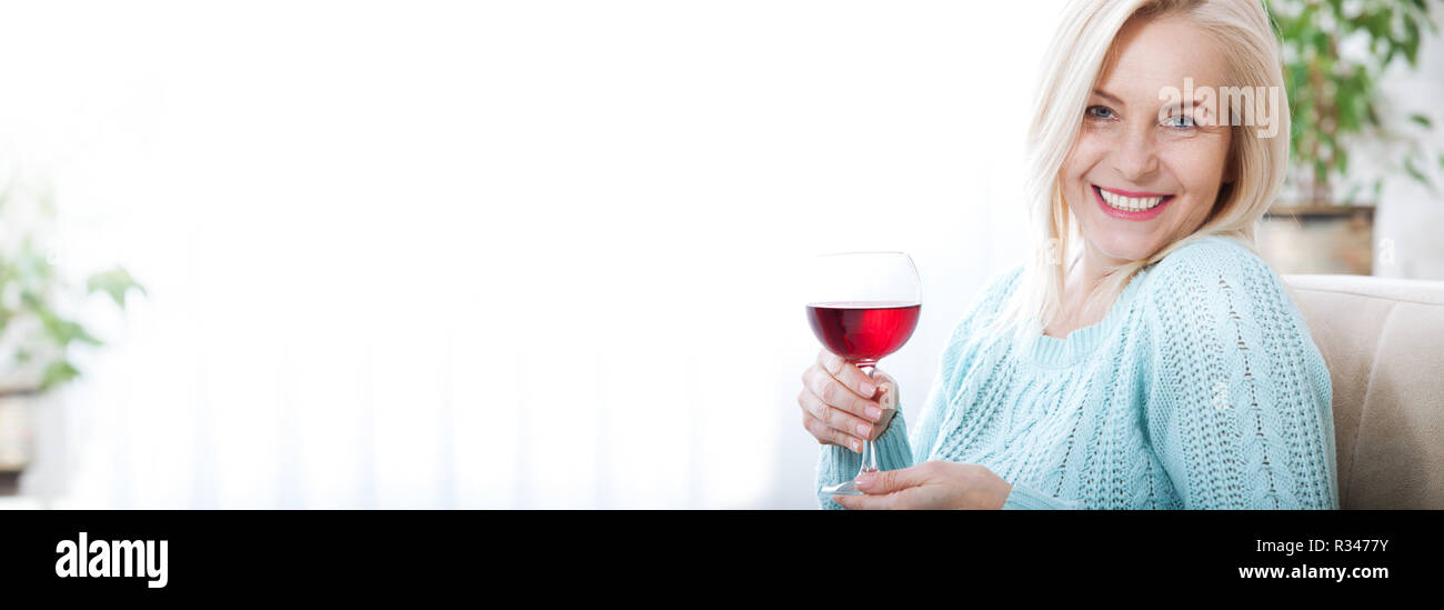 Beautiful middle aged woman drinking red wine. Stock Photo