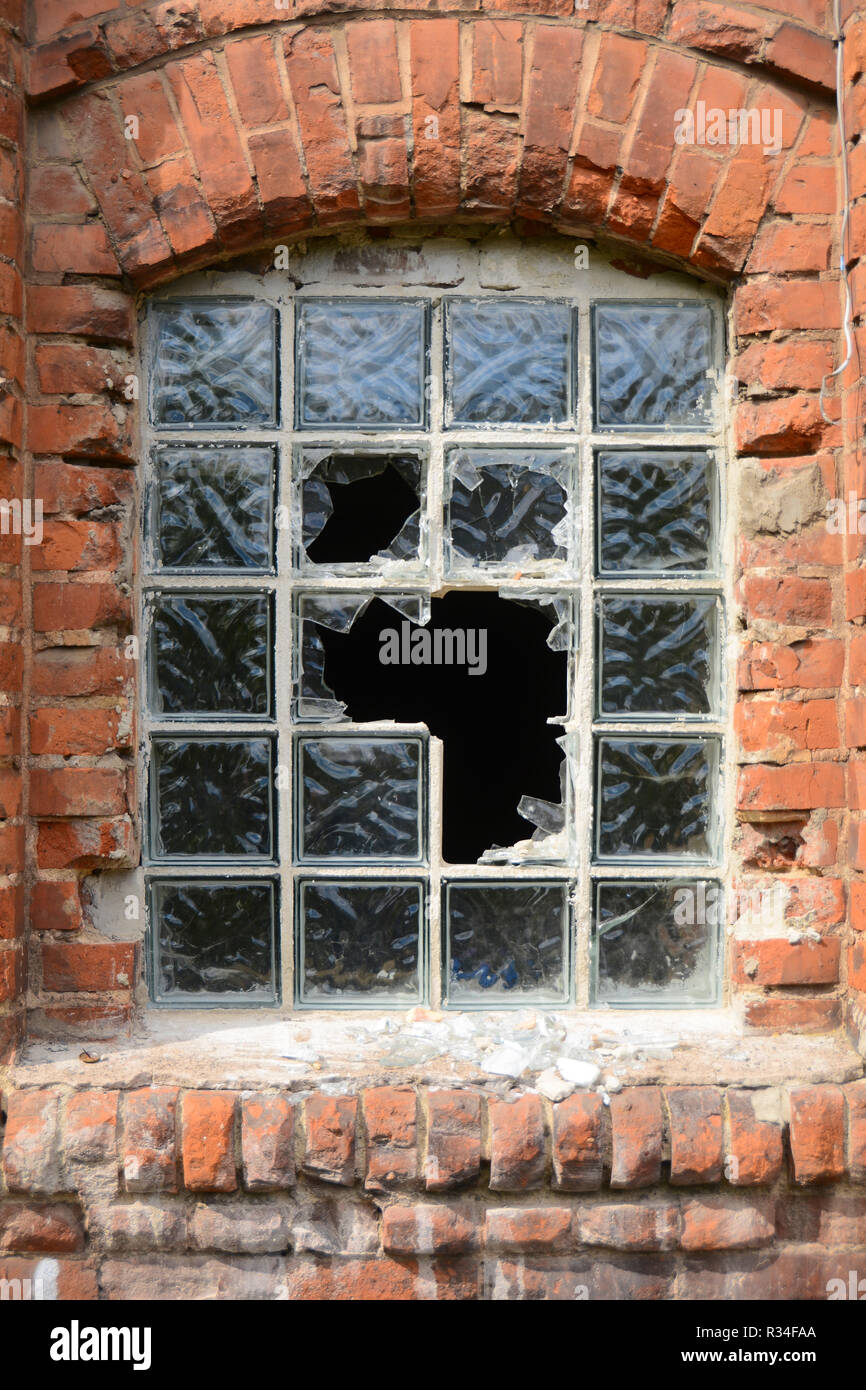 destroyed window in a disused factory Stock Photo