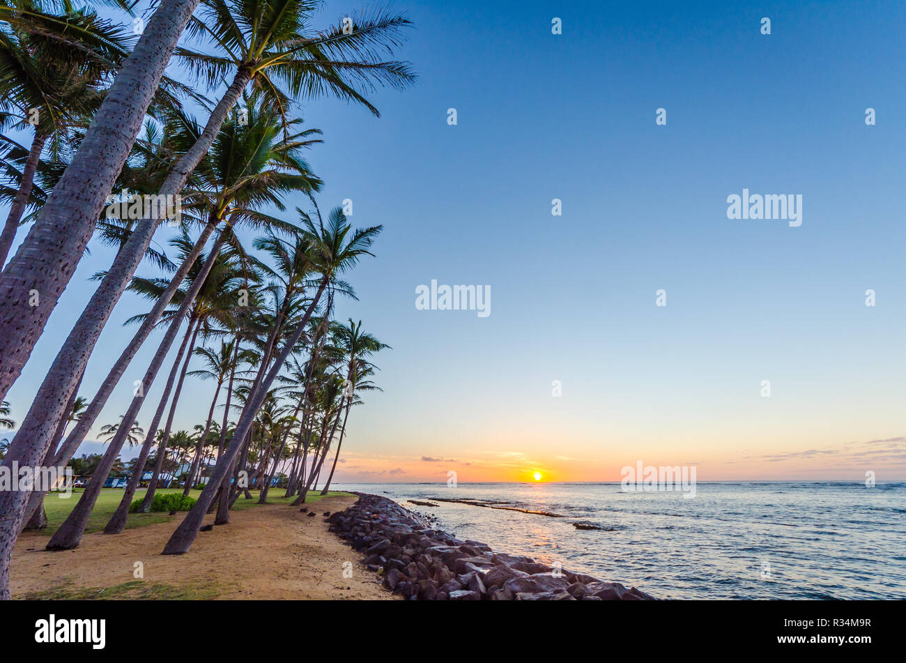 A view from the beach in Kapaa, Kauai, Hawaii, USA of the sun rising on