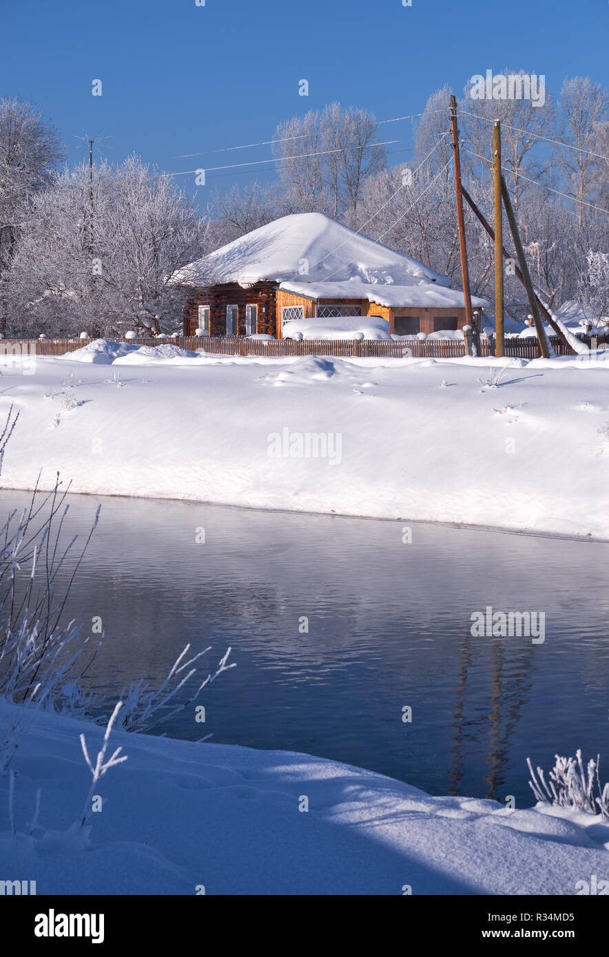 Altai russian country village Talitsa under winter snow on bank of river. Altai, Siberia, Russia Stock Photo