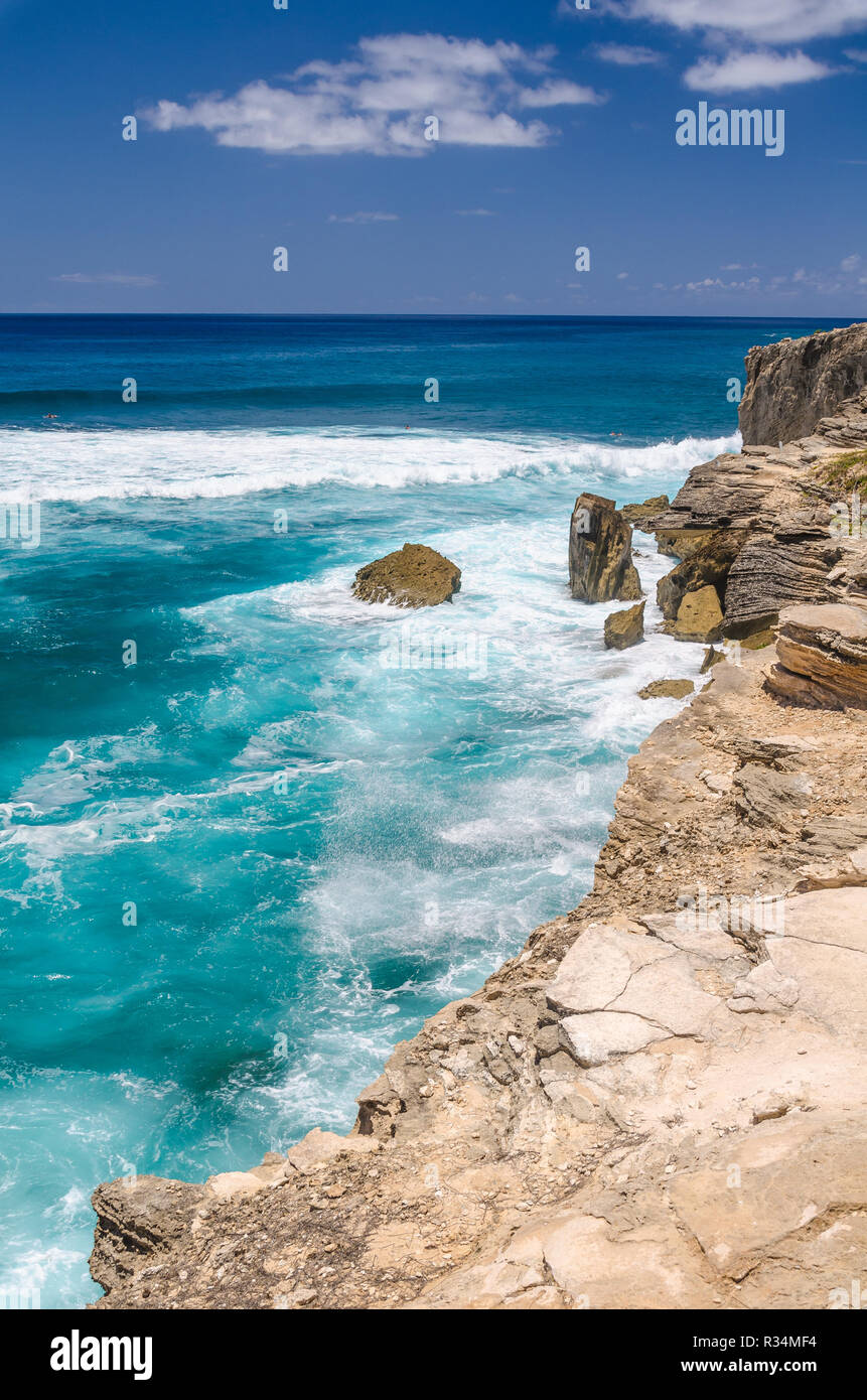 Ocean waves crashing into the rocky coastline of the Mahaulepu Heritage Beach Trail in Kauai, Hawaii, USA Stock Photo